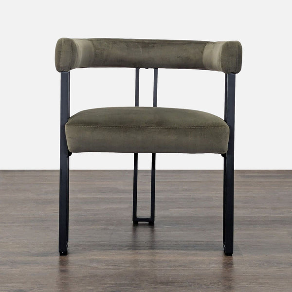 Metal dining chair with cushioned seat and backrest, featuring a sleek upholstered design.  