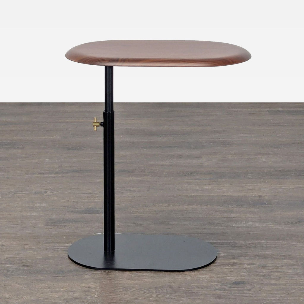Adjustable side table with a wooden top and black powder-coated steel base by Article.  