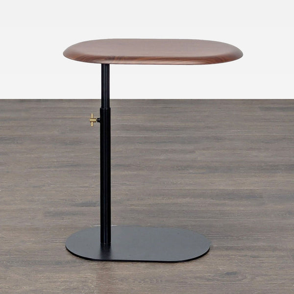 Adjustable side table with a wooden top and black powder-coated steel base by Article.  