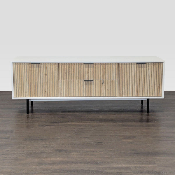West Elm entertainment center with white frame, wood doors, and drawers on metal legs.
