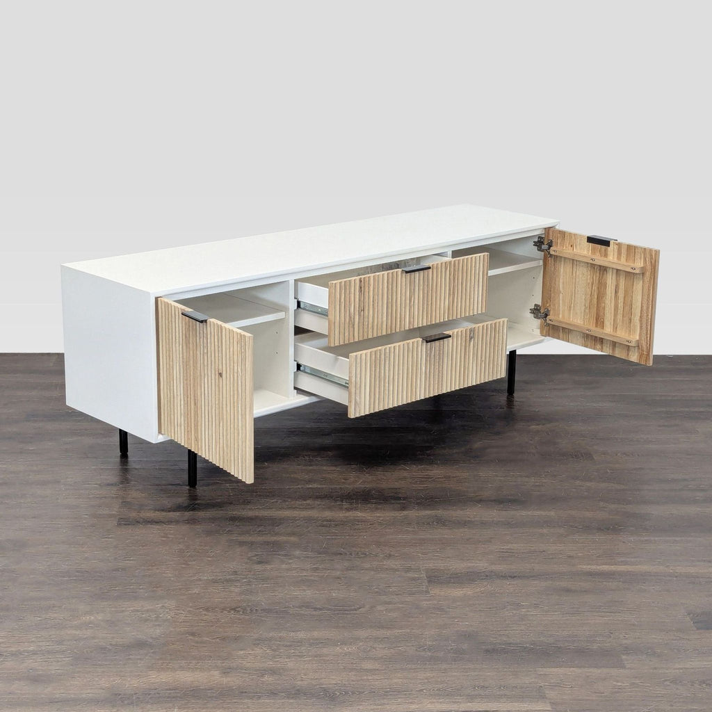 Modern white and wood West Elm TV stand featuring two central drawers and side cabinets.
