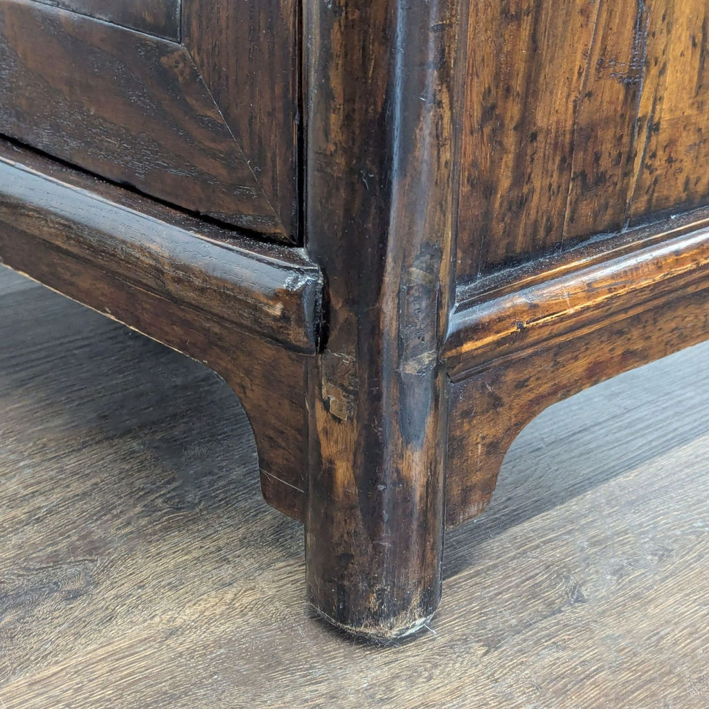 Antique-style wooden cabinet with detailed round metal lock, rich finish, and organized storage compartments.