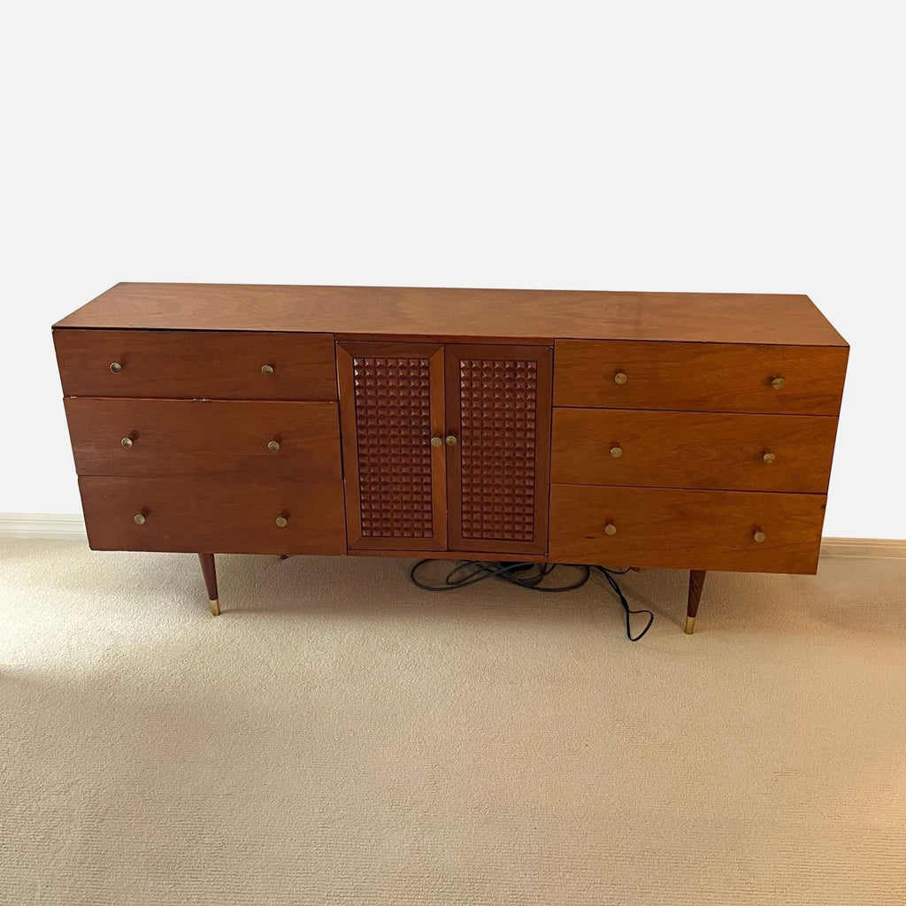 Six-drawer dresser featuring mid-century style, detailed cabinet doors, and brass accents, ideal for living rooms.