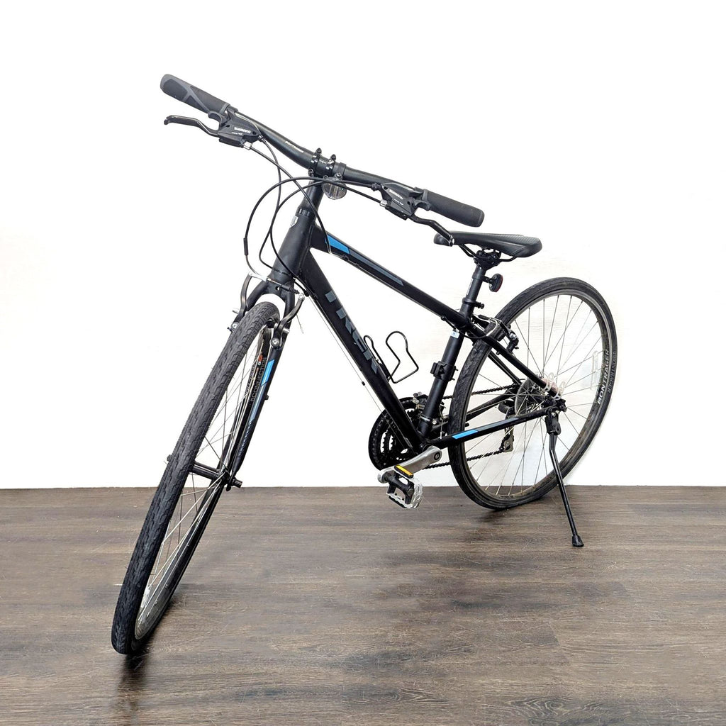 2. Angled front view of a Trek hybrid bicycle highlighting its smooth tires and comfortable saddle for outdoor use.