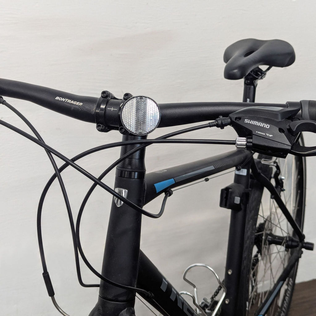3. Closeup of Trek bike handlebars, gear shifter, and frame details, highlighting reliable city-ride features.