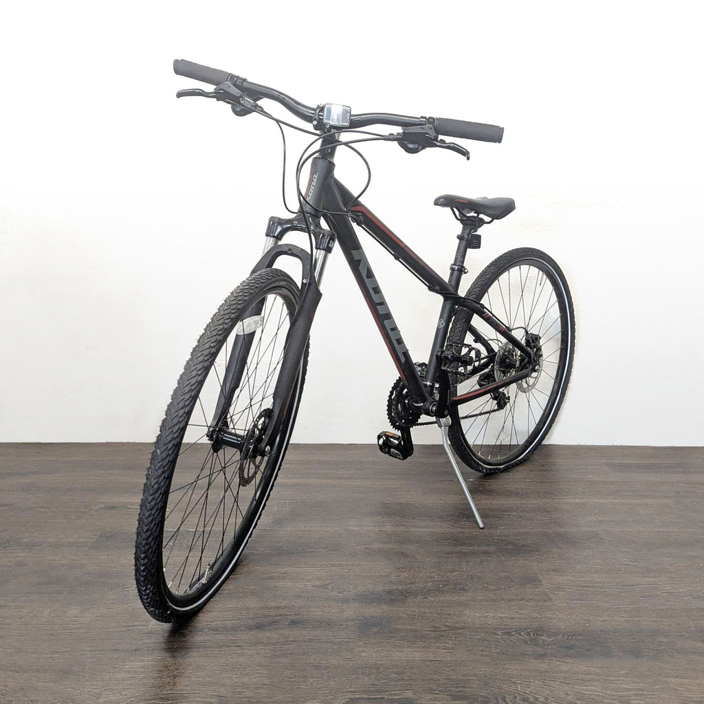 Kona hybrid bike with a 19” frame, 21-speed Shimano gears, and disc brakes, shown outdoors.  