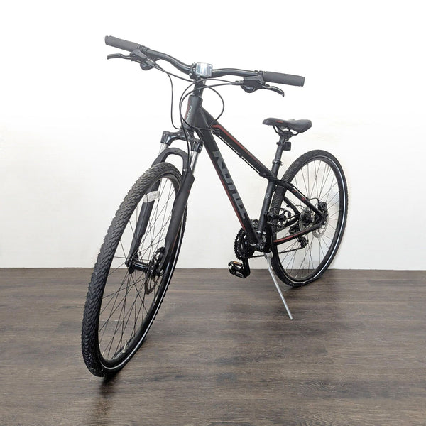 Kona hybrid bike with a 19” frame, 21-speed Shimano gears, and disc brakes, shown outdoors.  