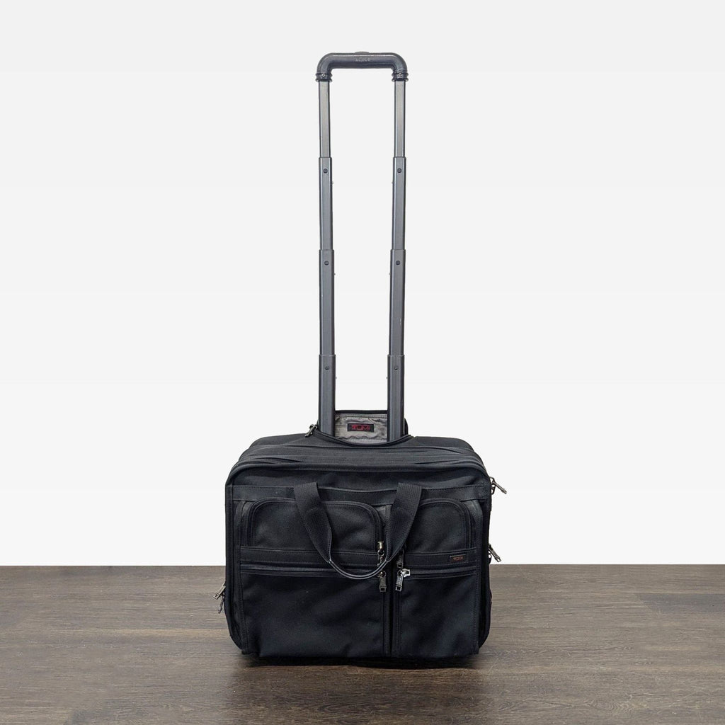 1. Sleek black Tumi suitcase featuring four spinner wheels and a telescopic handle.