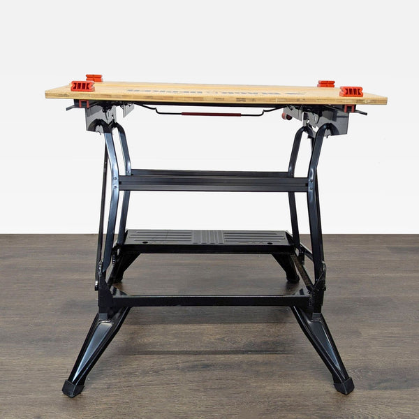 Black & Decker Workmate WM125 portable workbench with steel frame, wooden top, and adjustable clamps.