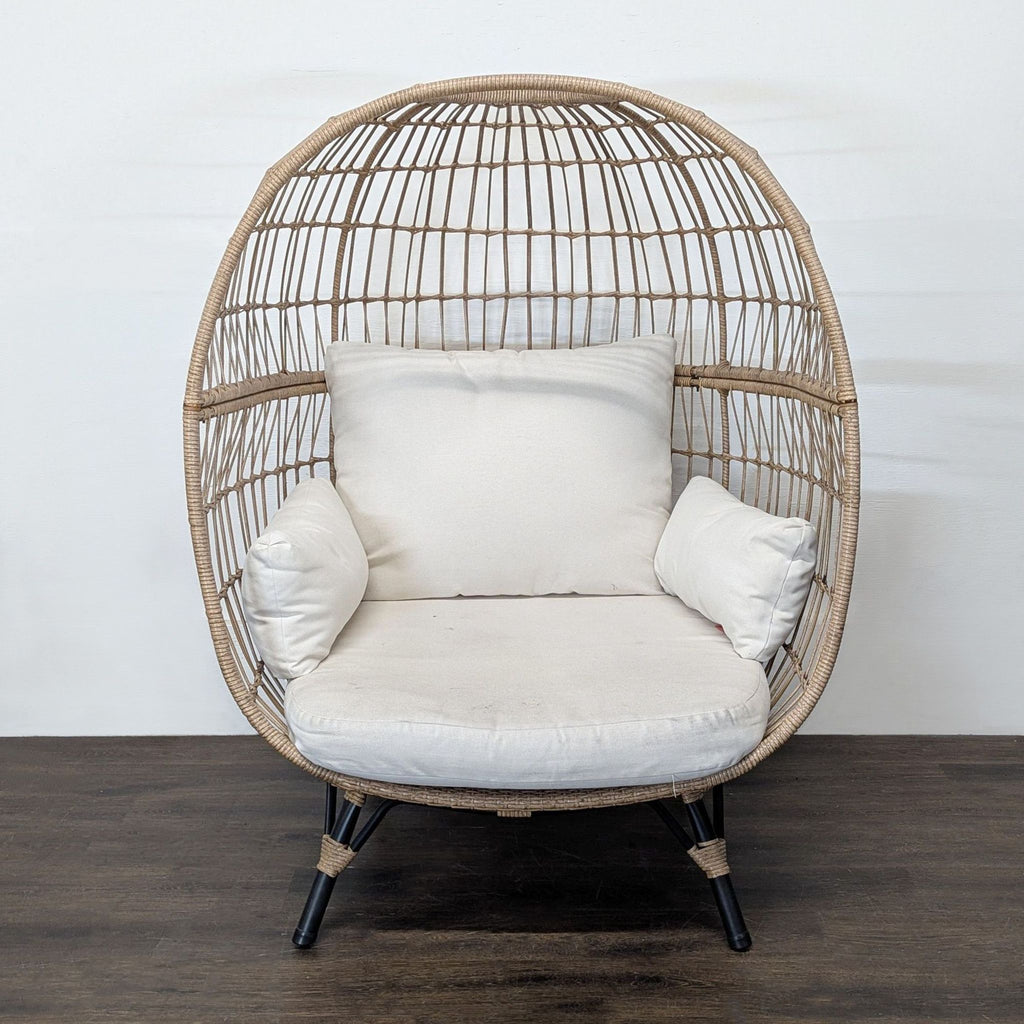 Opal House egg chair with a rattan-style frame and cream cushions, gently used and stylish for any room.  