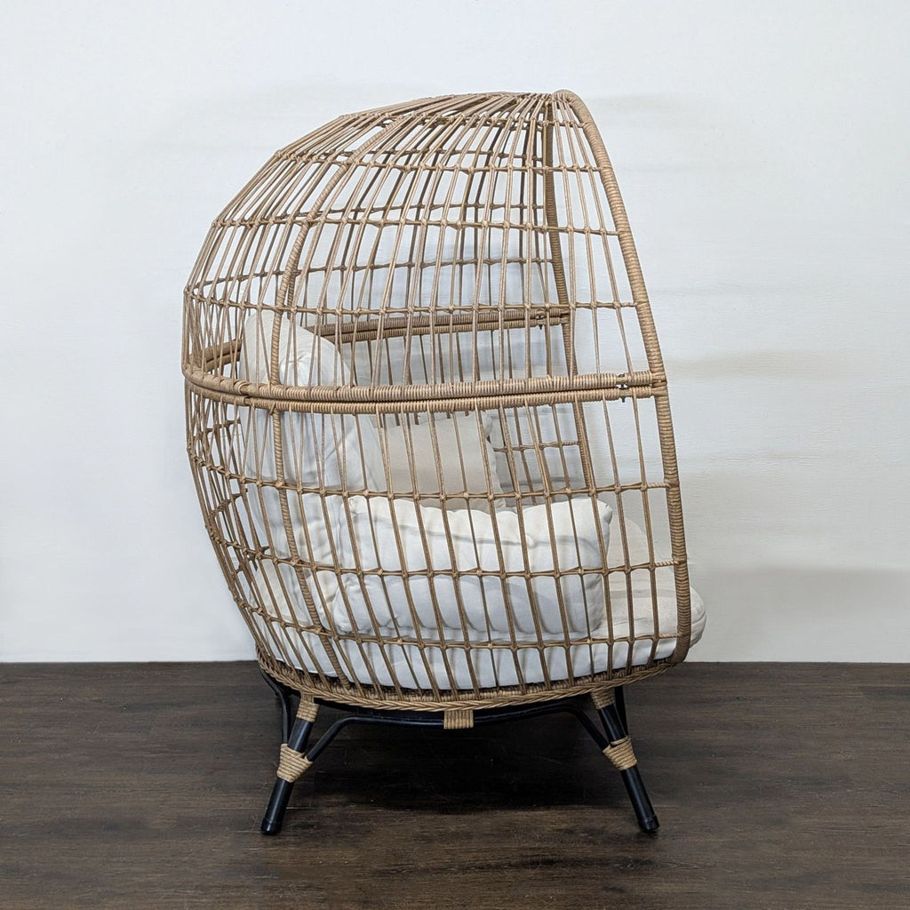 Cozy Opal House egg chair in good condition, with a sturdy woven frame and inviting cream cushions.