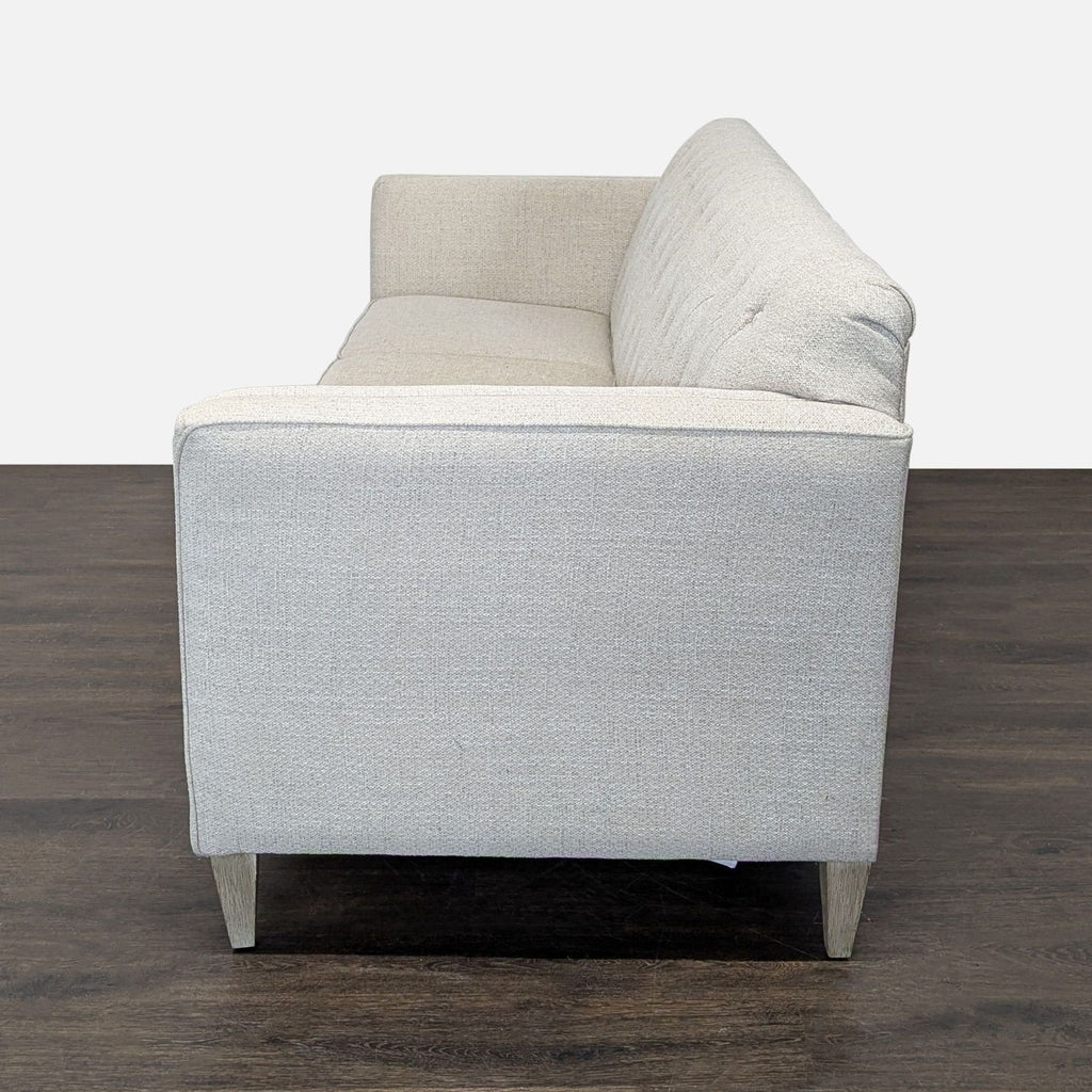 Beige La-Z-Boy 3-seat sofa with tufted back, comfortable cushions, slim arms, and stable wooden legs for any living room.
