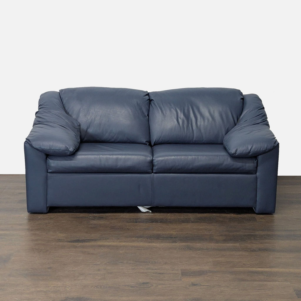 Krause's blue leather sleeper sofa with a pull-out bed, offering stylish comfort for living rooms or guest spaces.