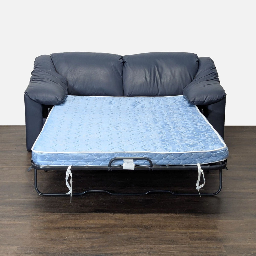 Blue leather sofa by Krause's that converts to a bed, perfect for maximizing space and hosting overnight guests.