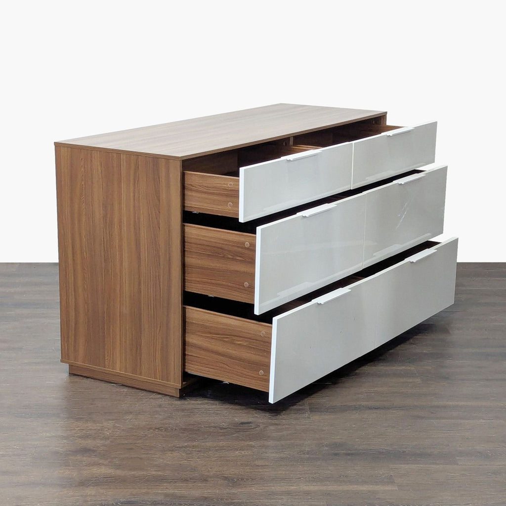 Sleek six-drawer dresser by Ikea, featuring a walnut body, white fronts, and spacious storage for clothes.