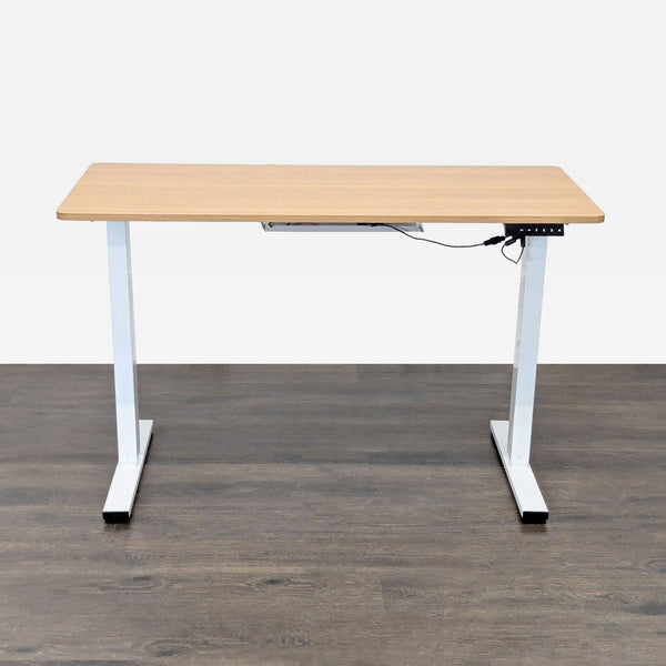 Electric height-adjustable desk by The Twillery Co., with a wood-look top and white metal legs.