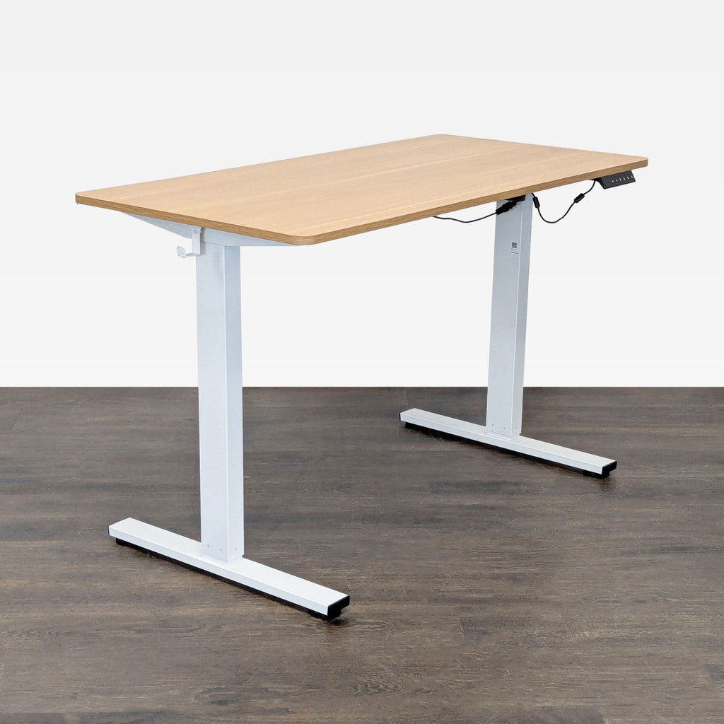 Sit-stand desk from The Twillery Co. featuring a spacious wooden surface, sturdy legs, and easy controls.