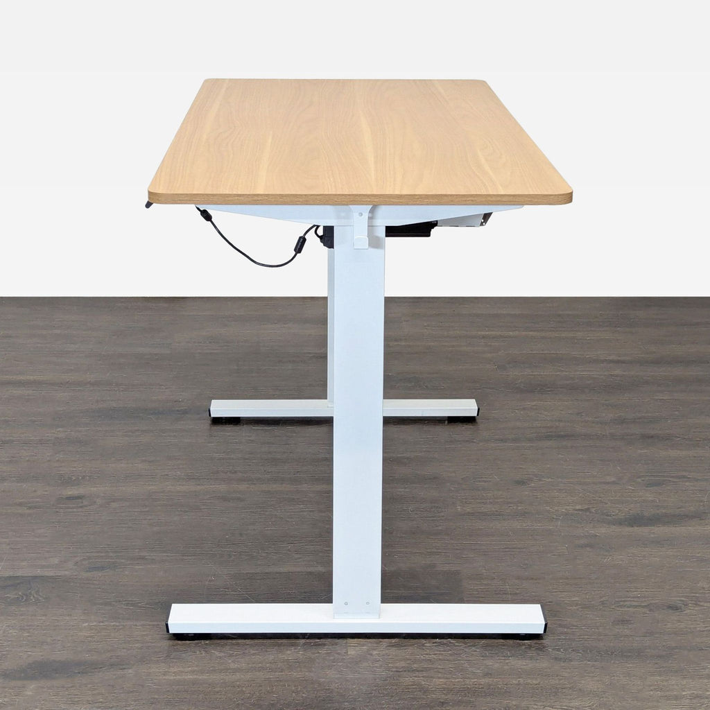 Modern The Twillery Co. desk with white frame and wood-style top, designed for adjustable height and comfort.