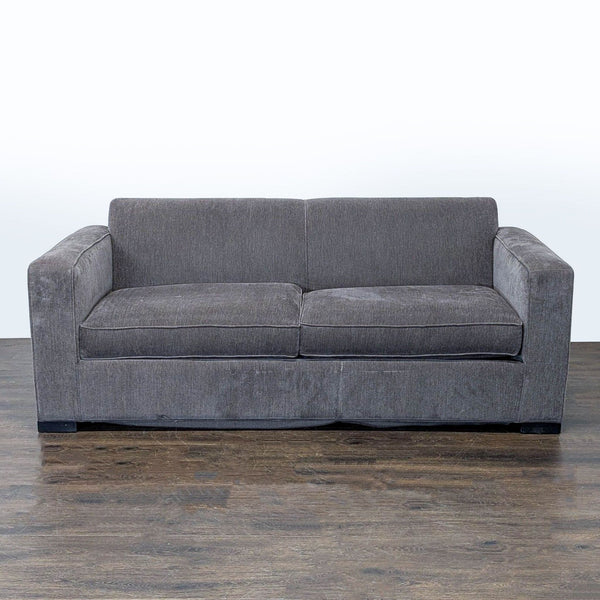 Gray McCreary Modern sleeper sofa with wide arms and plush cushions, shown in a contemporary living area.