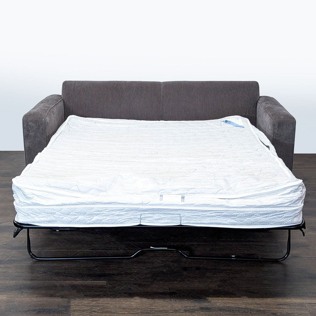 Modern gray McCreary Modern sofa that converts into a bed, offering generous seating and comfortable support.