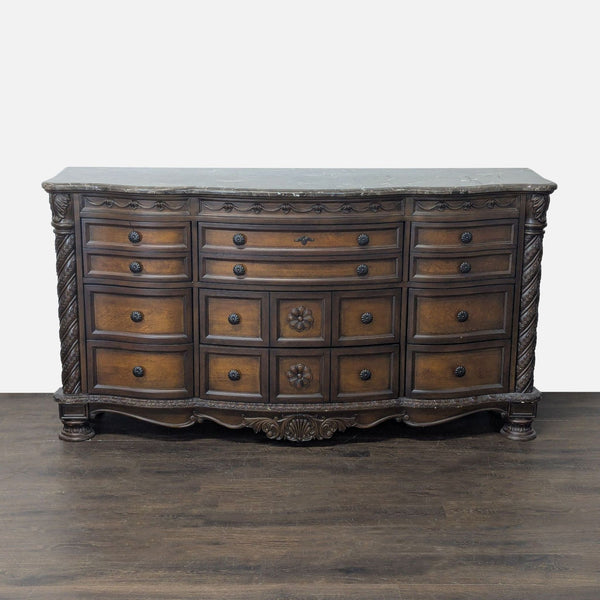 Ashley Furniture dresser with 12 drawers and a marble top, featuring classic carved details and brown finish.