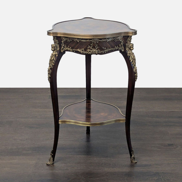 Antique mahogany and brass-trimmed circular side table with ornate legs from Theodore Alexander.