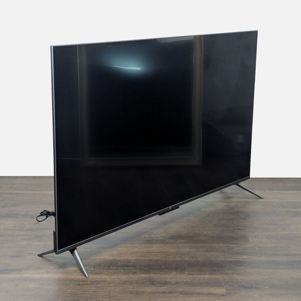 Large Amazon smart TV with crisp UHD display, sleek profile, and stable stand, perfect for streaming.  