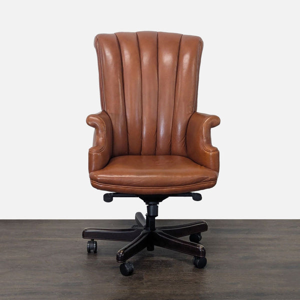 Hancock & Moore chair with brown leather upholstery, channeled back, and wood base with casters.