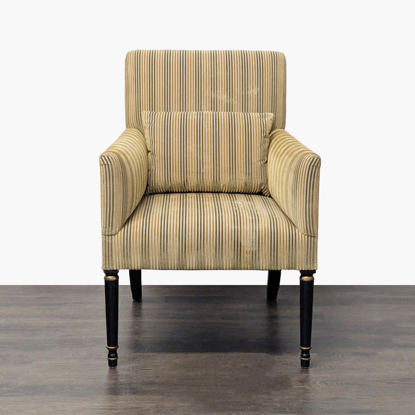 Dessin Fournir lounge armchair with tall striped gold and neutral back, gold pillow, and ebonized wood legs.