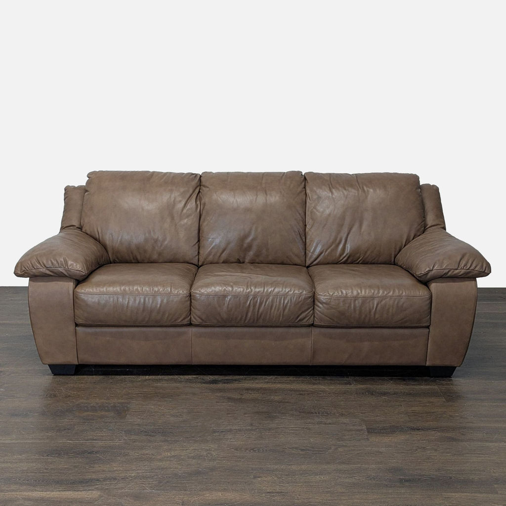 Brown leather Italsofa 3-seat sofa with plush cushions and padded armrests, ideal for a modern living room.