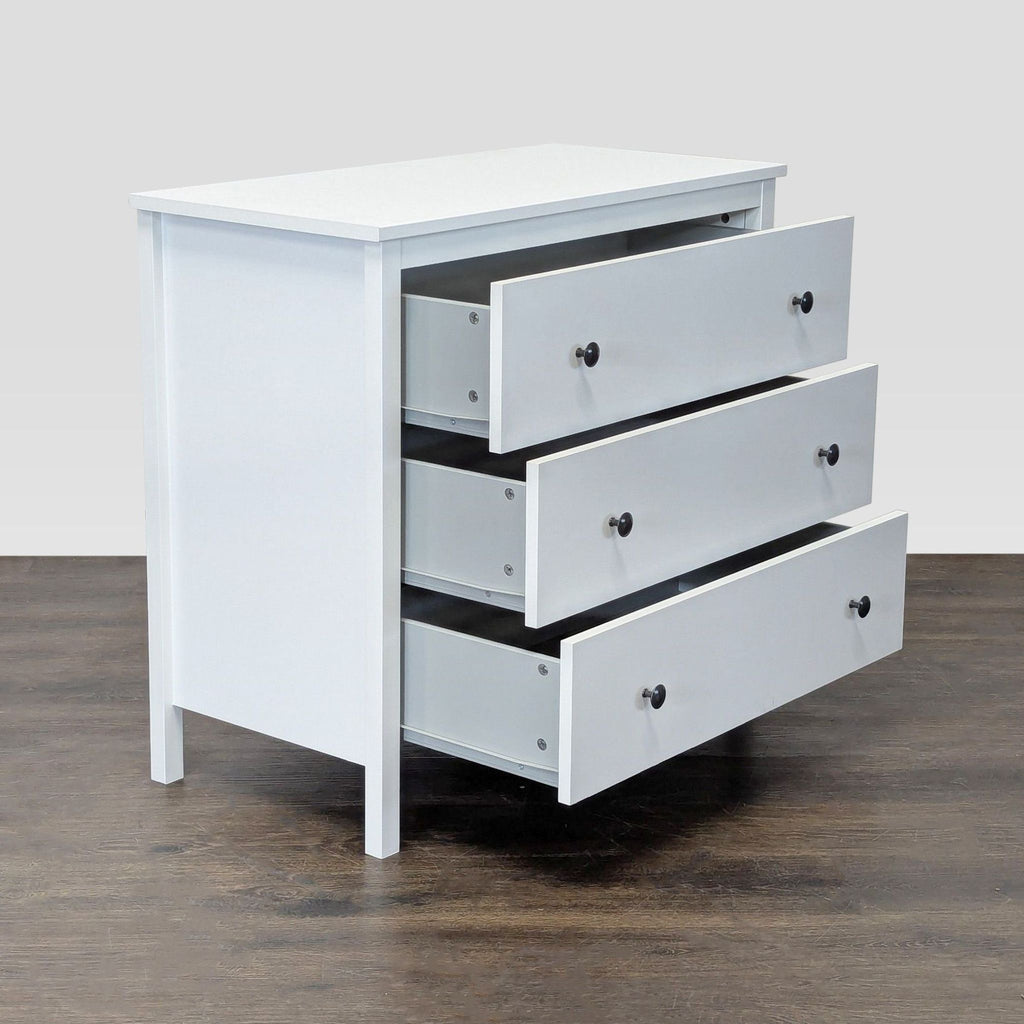 Sleek white dresser featuring three spacious drawers, black hardware, and minimalist style.