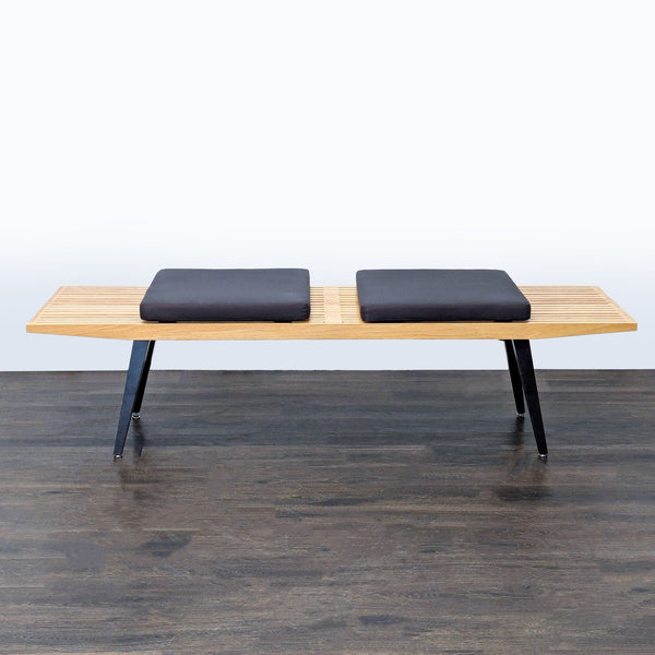 Angled tapered metal legs attached to the base of a stool, ottoman, or bench.