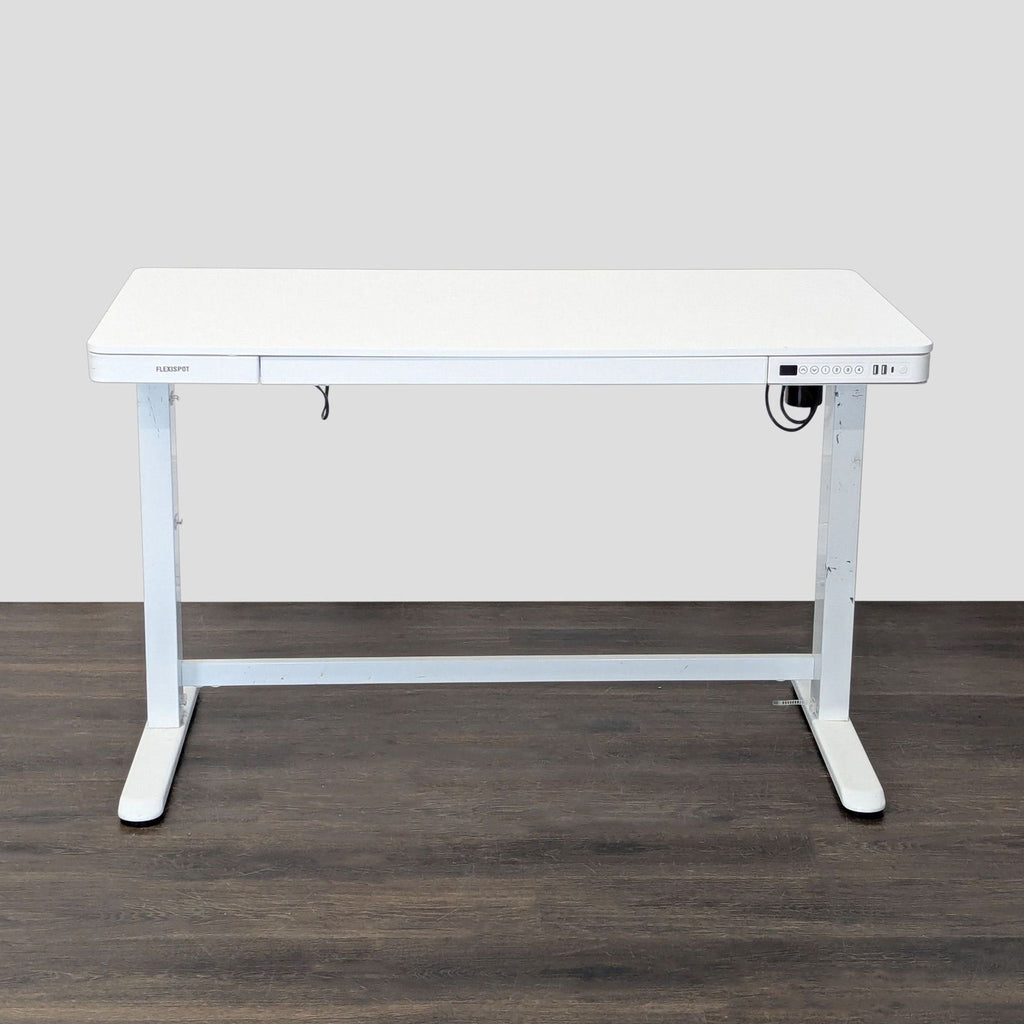 Modern white Flexispot desk with electric height adjustment, control panel, and storage drawer for versatile office use.