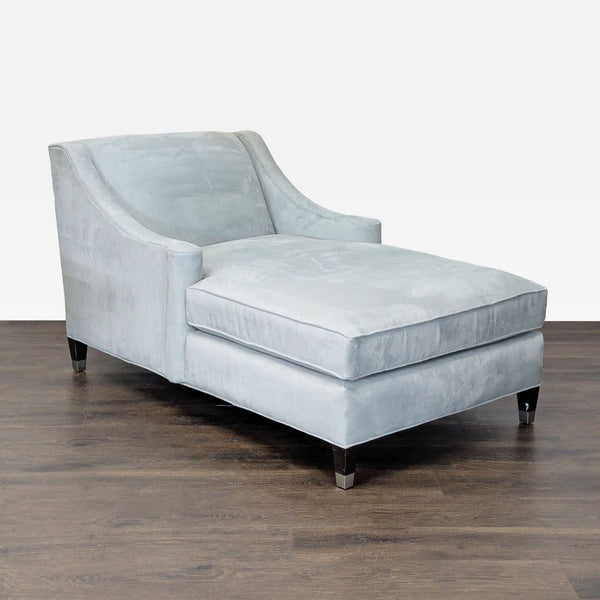 Modern light blue velvet chaise lounge with wide cushioned seat and supportive backrest for comfort.  
