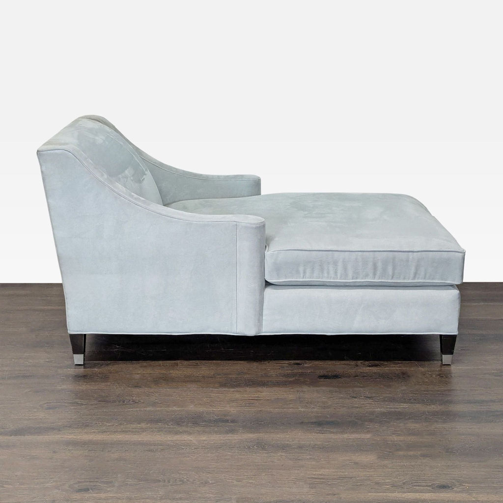Elegant, contemporary chaise lounge in light blue velvet, designed for stylish relaxation in living spaces.
