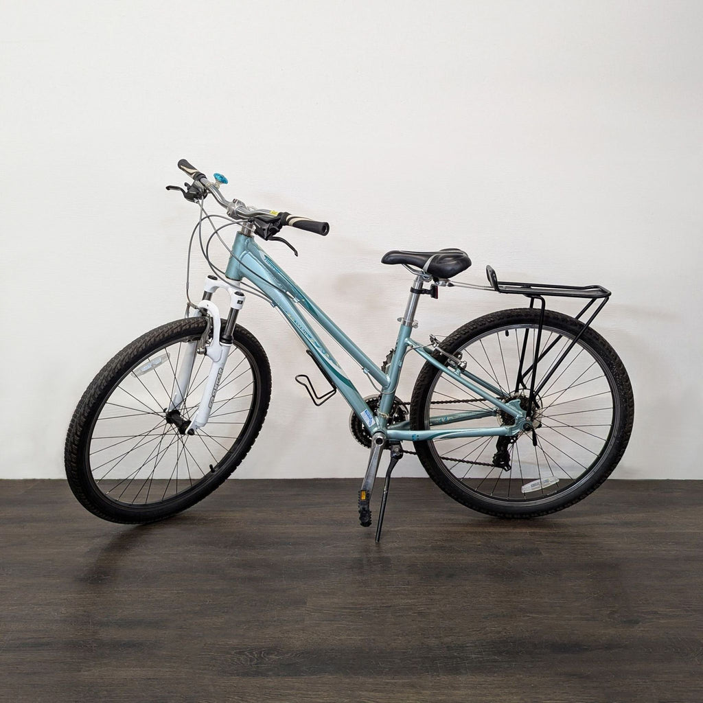 Giant outdoor bike with sturdy frame, front suspension, rear rack, and comfy saddle, ideal for commuting or trails.  