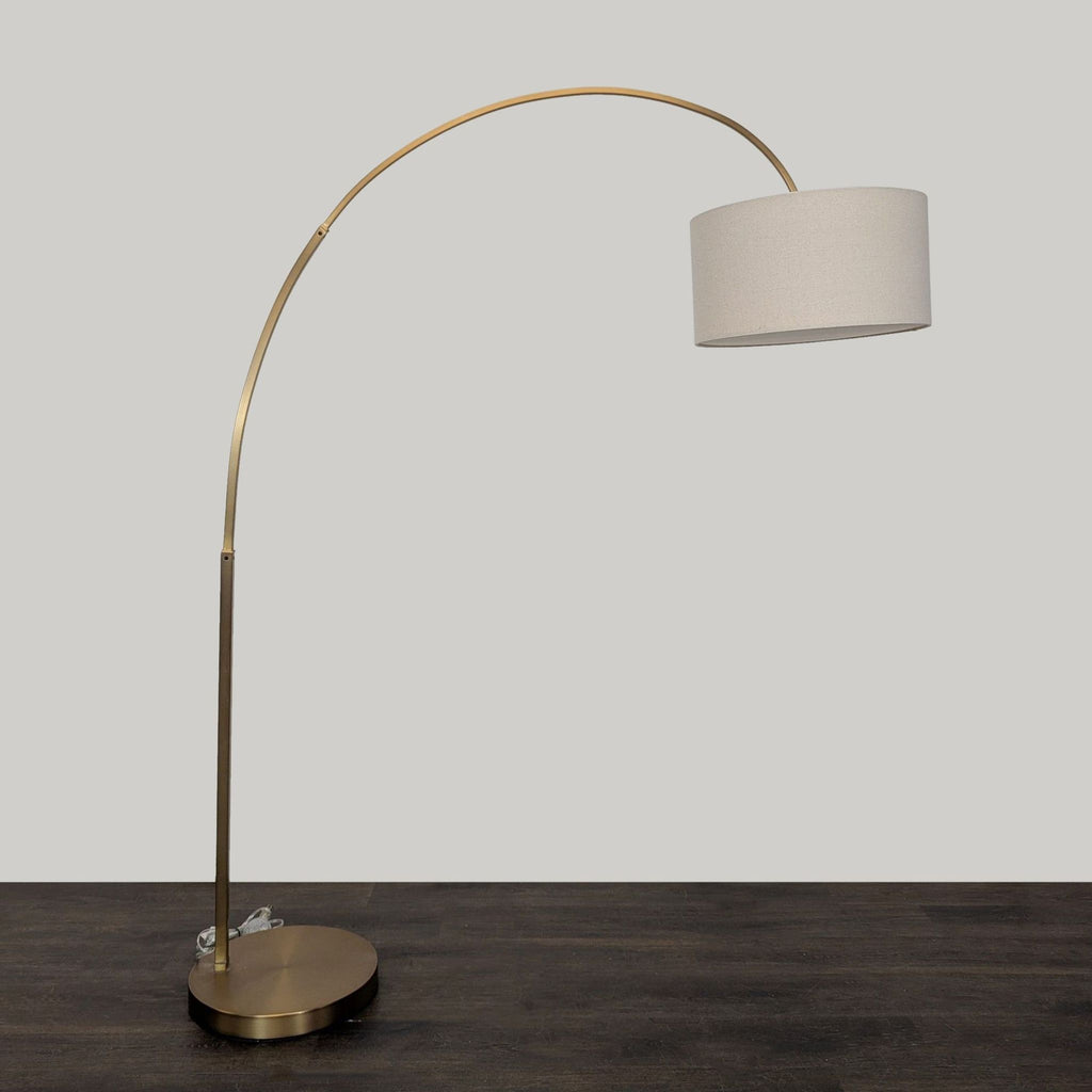 Contemporary floor lamp featuring a sturdy brass frame, large round base, and soft-glow fabric shade.