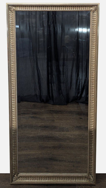 Decorative mirror with carved leafy corners and bead detailing around its border.  