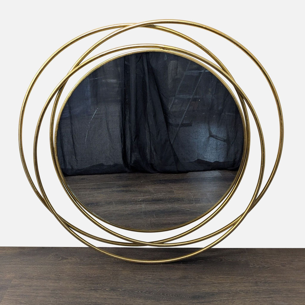 Round wall mirror with polished gold iron frame and reflective glass by UMA Enterprises, Inc.