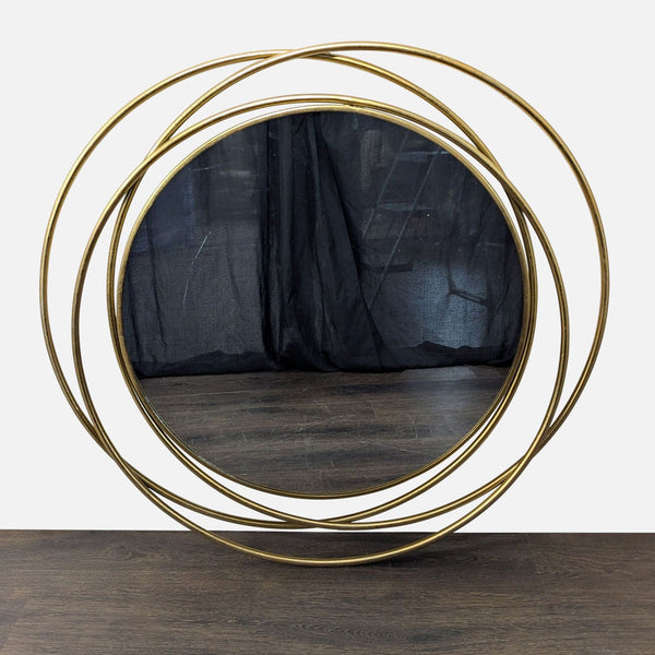 Round wall mirror with polished gold iron frame and reflective glass by UMA Enterprises, Inc.