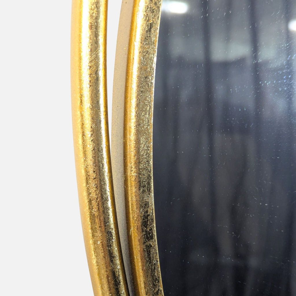 Decorative polished gold metal wall mirror from UMA Enterprises, Inc., featuring reflective glass surface.