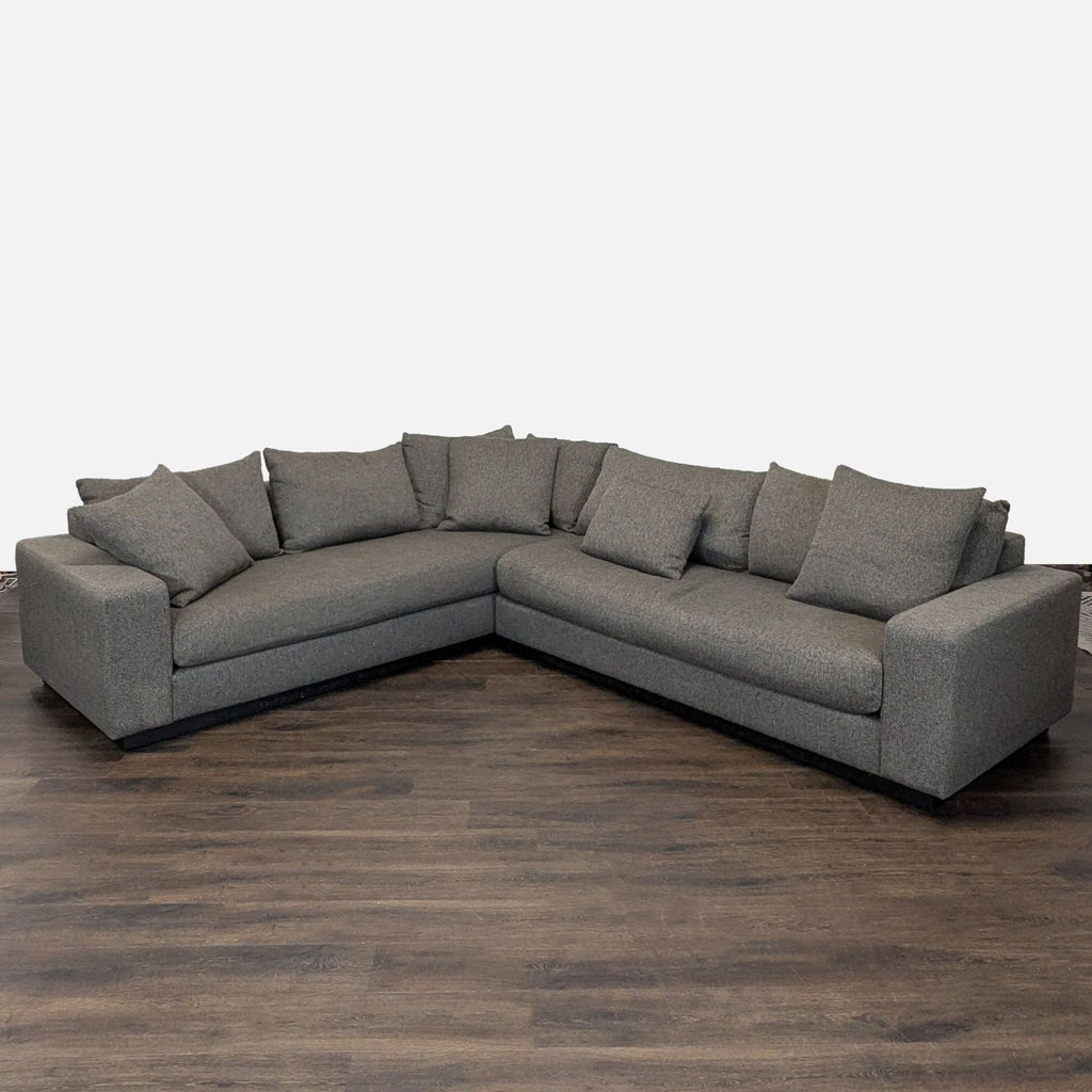 Rene Cazares sectional sofa in gray fabric with removable cushions, offering ample, stylish seating for living rooms.