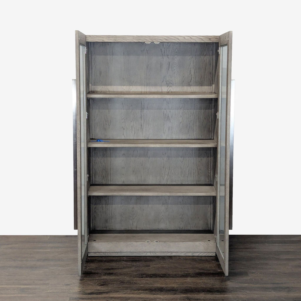 1. Elegant Restoration Hardware cabinet with glass doors and sleek metal handles, ideal for modern interiors.