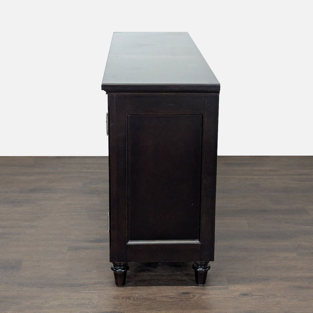 Elegant Bernhardt sideboard with spacious cabinets, lined silverware drawer, and pull-out trays in a rich finish.