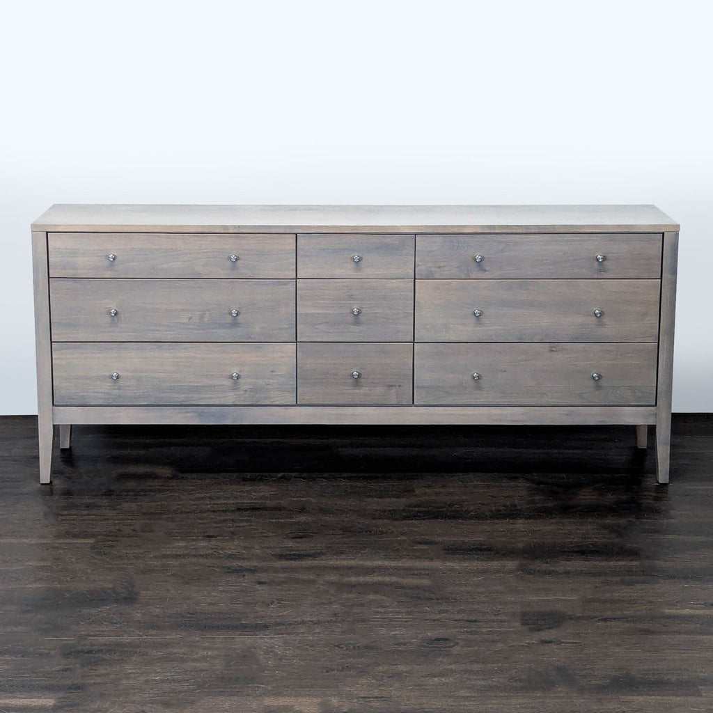 Modern light gray Room and Board dresser with 9 drawers and simple knob handles, ideal for bedroom storage.
