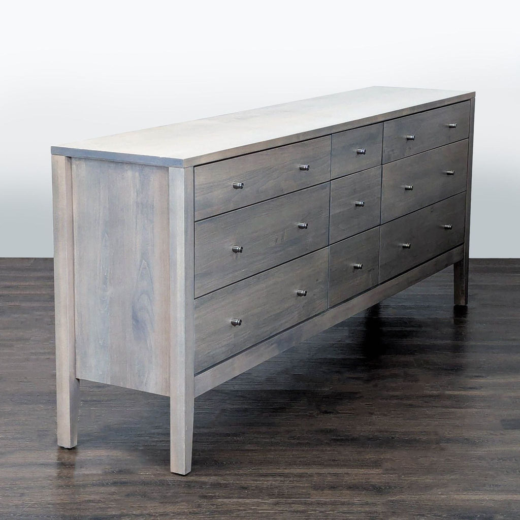 Sleek 9-drawer Room and Board dresser with minimalist design and ample storage, fitting contemporary bedroom décor.