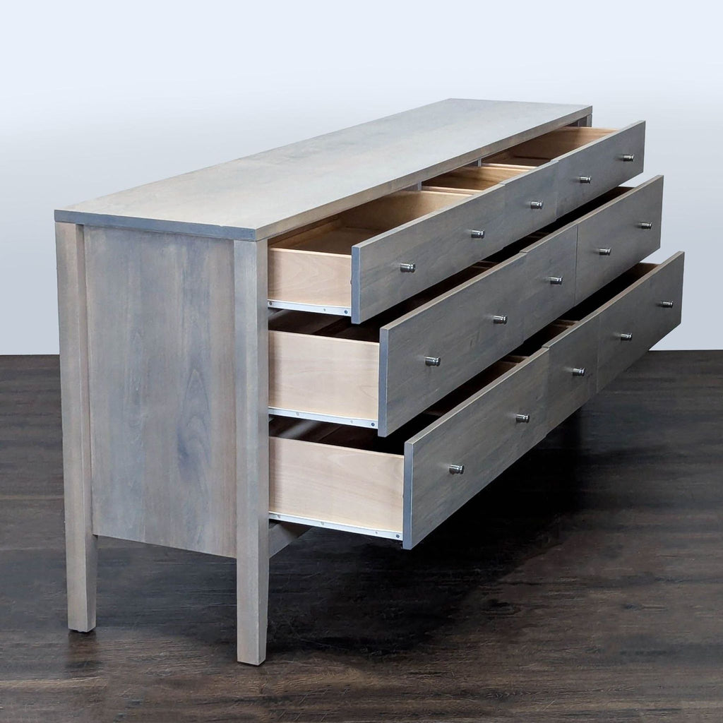 Room and Board dresser in light gray wood, featuring 9 spacious drawers and sturdy legs for versatile organization.