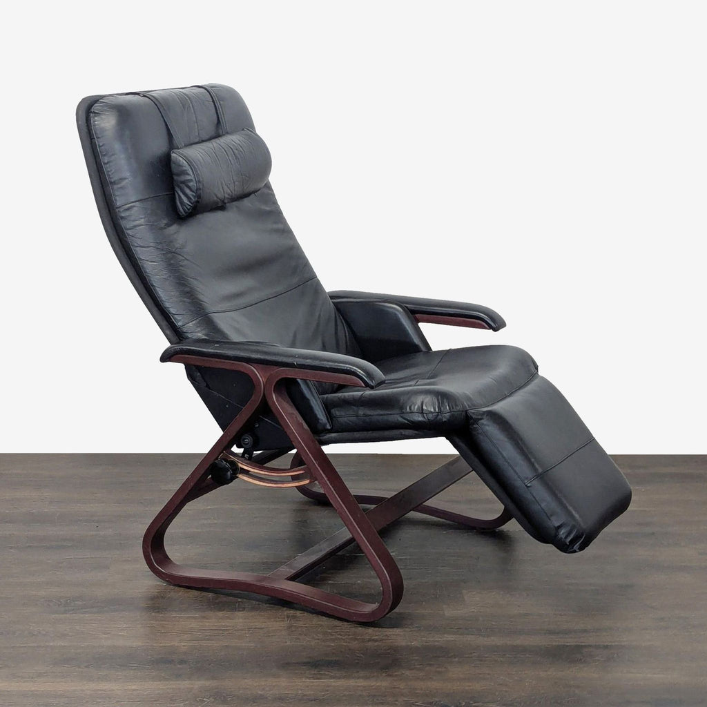 Black leather Relax The Back lounge chair with wooden frame, cushioned headrest, and padded armrests.