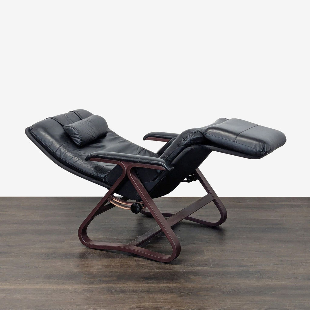 Sleek reclining lounge chair by Relax The Back in black leather, featuring ergonomic support and wooden accents.
