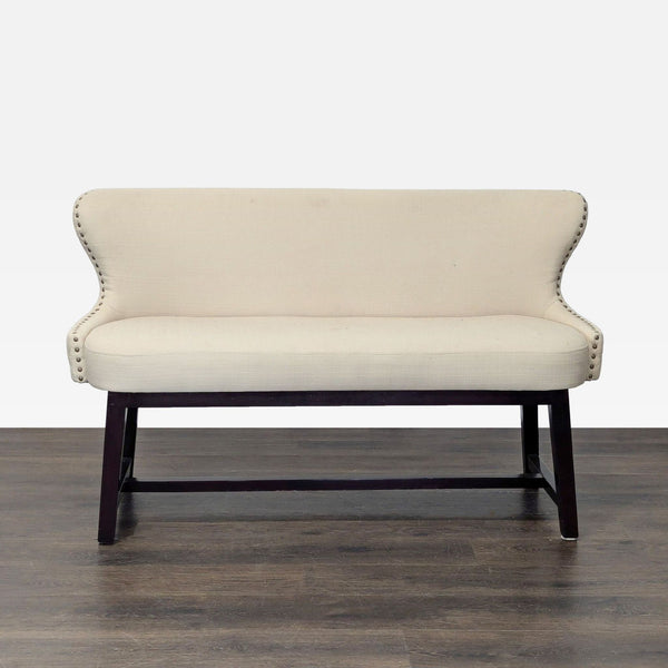 Wing-style bench with quilted back, nailhead trim, and wooden frame, ideal for seating in any room.